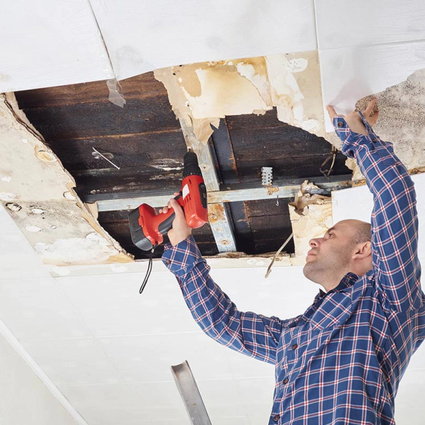man fixing water damage on ceiling brigham city ut